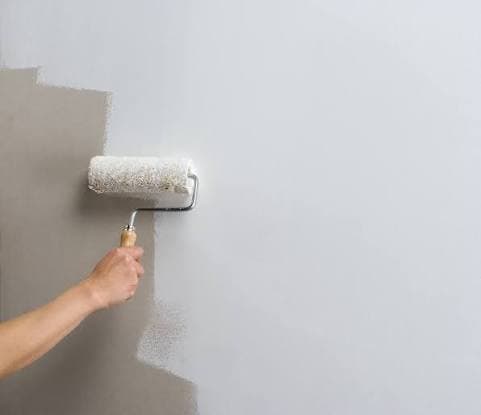 Craftsperson preparing a wall surface